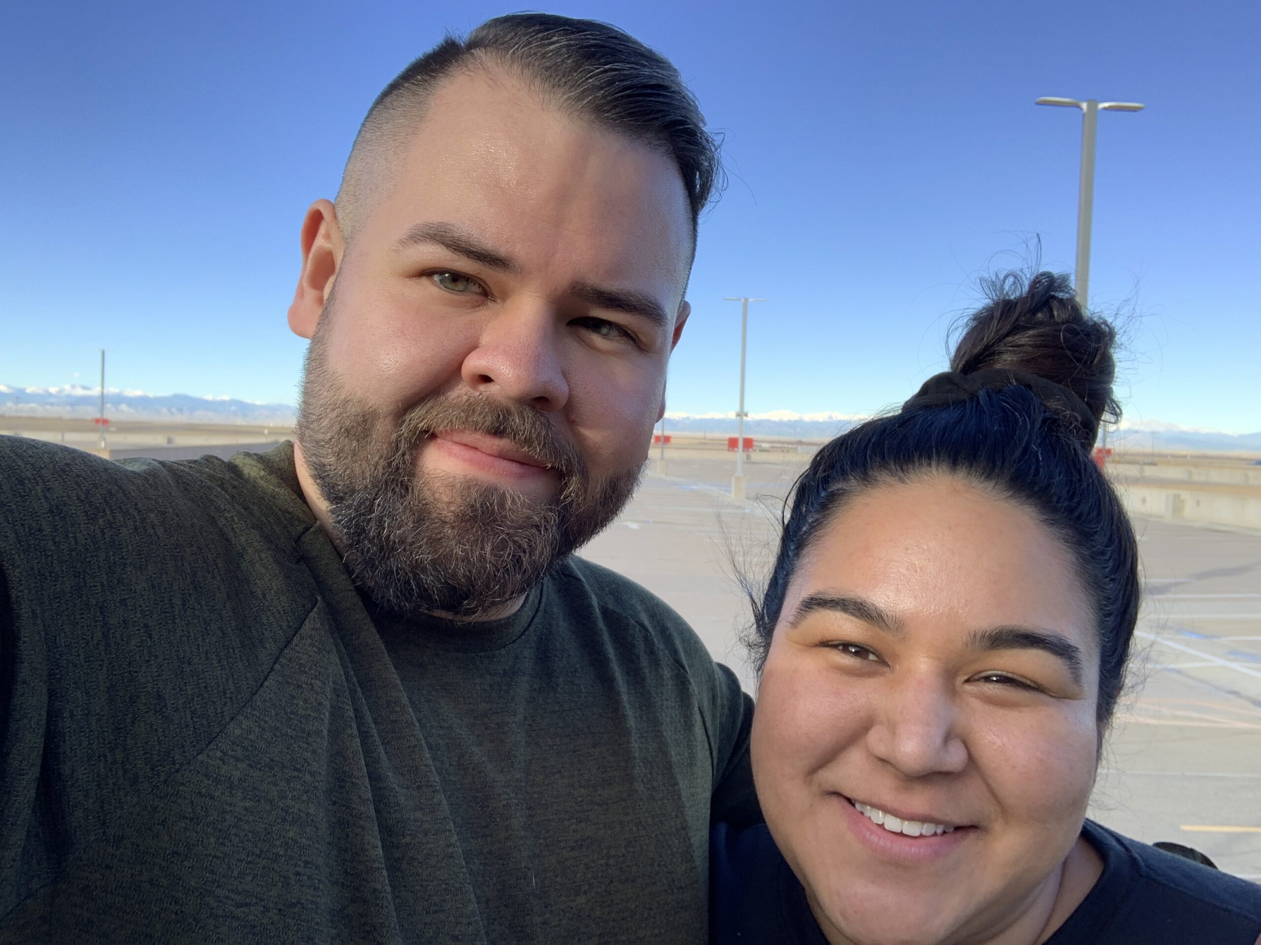 Jordan Crandell with Emily in a parking lot.